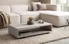 A modern living room scene featuring a sectional sofa and a rectangular coffee table. Anteprima dell’immagine prodotto