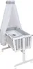 A white baby crib with a canopy and bedding. Produktbild-Vorschau