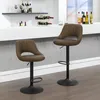 Two brown bar stools in a modern bar setting. Produktbild-Vorschau