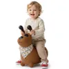 A child is riding a brown dog-shaped inflatable toy. Produktbild-Vorschau