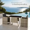 A rattan seating set with a table and two chairs is placed on a patio next to a swimming pool with a scenic ocean view. Náhled obrázku produktu