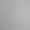 A close-up view of a textured gray surface, possibly a wall or a product casing, with a subtle diagonal line or seam. Produktbild-Vorschau