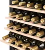 Rows of wine bottles stored on wooden shelves inside a wine cooler. Produktbild-Vorschau