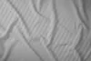 A close-up, overhead view of a light gray striped satin bedsheet. Anteprima dell’immagine prodotto