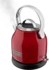 A red electric kettle is steaming on its black base, set against a white background. Produktbild-Vorschau