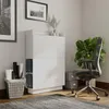 A modern home office setup with a white secretary desk, chair, plant, and storage basket. Produktbild-Vorschau