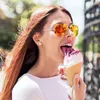 A woman is eating ice cream outdoors. Náhled obrázku produktu
