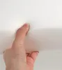 A hand is pressing into a white foam material. Produktbild-Vorschau