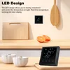 A smart thermostat is displayed on a shelf with kitchen items. Podgląd zdjęcia produktu