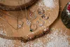 Jewelry laid out on a wooden surface with scattered artificial snow. Anteprima dell’immagine prodotto