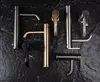 A collection of modern faucets arranged on a dark, textured surface. Anteprima dell’immagine prodotto