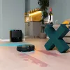 A robot vacuum cleaner is cleaning up a spill on a floor, with a docking station in the background. Produktbild-Vorschau
