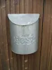 A galvanized metal mailbox is mounted on a wooden fence. Produktbild-Vorschau