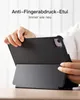 Hands holding a black tablet case with a stand feature, on a wooden table. Produktbild-Vorschau