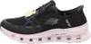 A side view of a black Skechers shoe with a white sole. Voir les images du produit