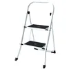 A white two-step stepladder with black treads is shown against a white background. Podgląd zdjęcia produktu
