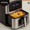 Close-up of an air fryer with french fries and chicken nuggets inside. Náhled obrázku produktu