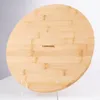 A round bamboo cutting board is displayed on a white surface, supported by clear stands. Produktbild-Vorschau