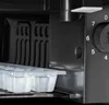 A close-up view of the interior of a refrigerator, showing an ice cube tray and a control dial. Produktbild-Vorschau
