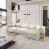 A modern living room with a large sectional sofa, coffee table, and abstract rug. Produktbild-Vorschau