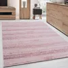 A pink rug with a striped pattern is shown in a room with wooden furniture. Podgląd zdjęcia produktu