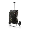 A shopping trolley with a polka dot pattern is shown against a white background. Voir les images du produit