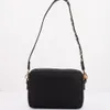 A black handbag is shown against a white background. Voir les images du produit