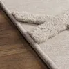 A close-up view of a rug with a textured pattern, placed on a wooden floor. Anteprima dell’immagine prodotto