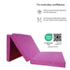A folded pink mattress is shown against a white background, with marketing text and logos. Podgląd zdjęcia produktu
