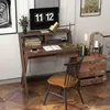 A compact wooden desk with a monitor, books, a lamp, and a chair, set up in a home office or study environment. Produktbild-Vorschau