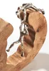 A close-up shot of a decorative figurine made of wood and metal, depicting a person climbing. Náhled obrázku produktu