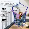 A woman relaxing in a colorful hammock chair on a balcony with a city view. Náhľad obrázku produktu
