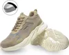 A pair of beige safety shoes with a steel toe cap shown in an inset. Produktbild-Vorschau