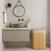 A modern bathroom vanity with a sink, faucet, mirror, and a bamboo laundry basket. Podgląd zdjęcia produktu