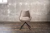 A single chair is shown in a room with a concrete wall and wooden floor. Produktbild-Vorschau