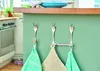 Kitchen counter with forks repurposed as hooks holding kitchen towels and a pot holder. Produktbild-Vorschau