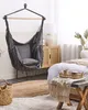 A cozy bedroom scene featuring a hanging chair, bed, and bedside table. Náhled obrázku produktu