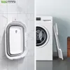A split image showing a foldable basin hanging on a tiled wall on the left, and the same basin leaning against a washing machine on the right. Voir les images du produit