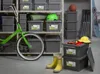 A storage room with shelves filled with grey storage boxes, a green bicycle, and yellow boots. Anteprima dell’immagine prodotto