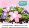 A collection of colorful, gem-like beads and charms arranged on moss, with tools for digging and crafting. Anteprima dell’immagine prodotto