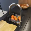 A kitchen sink area with a faucet, a basket of oranges, and a cutting board. Produktbild-Vorschau