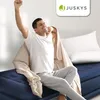 A man is stretching on a blue air mattress with a blanket draped over him. Produktbild-Vorschau