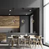 A dining room with a table and chairs, and pendant lights hanging from the ceiling. Podgląd zdjęcia produktu