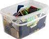A clear, well-lit studio shot of a clear plastic tub filled with various colored plastic shims or wedges. Produktbild-Vorschau