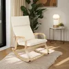 A rocking chair is placed on a fluffy rug in a well-lit room, with a plant and a lamp on a side table in the background. Voir les images du produit