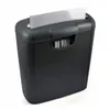 A black paper shredder with a piece of paper being fed into it. Voir les images du produit