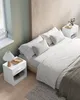 A bedroom scene with a bed, nightstands, and bedding. Náhled obrázku produktu