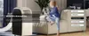 A young girl sits on a couch next to a portable air conditioner in a living room. Produktbild-Vorschau