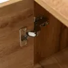 A close-up view of a cabinet hinge on a wooden surface. Anteprima dell’immagine prodotto