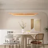 A modern dining room setting with a pendant light over a table. Voir les images du produit